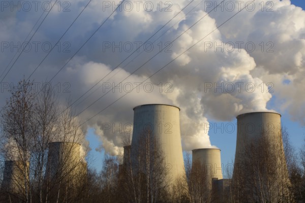 Steam rises from the cooling towers of the Vattenfall power plant in Jänschwalde, power lines and