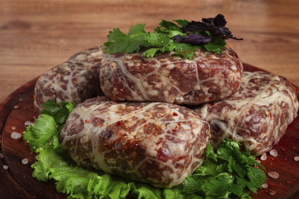 Raw apkhazura, a dish of Georgian cuisine, meat balls, minced meat wrapped in a fat net, seftalia,