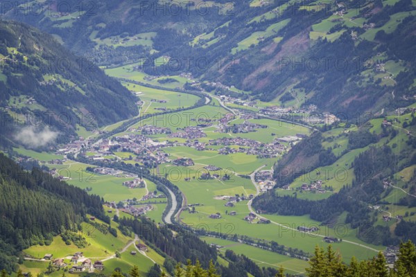 Green valley with village and river in the Alps, surrounded by mountains, Mayrhofen, Zillertal.