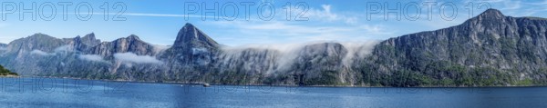 Panorama of fjord Mefjord with famous peaks Hesten, Segla and Grytetippen, salmon farm, Senja