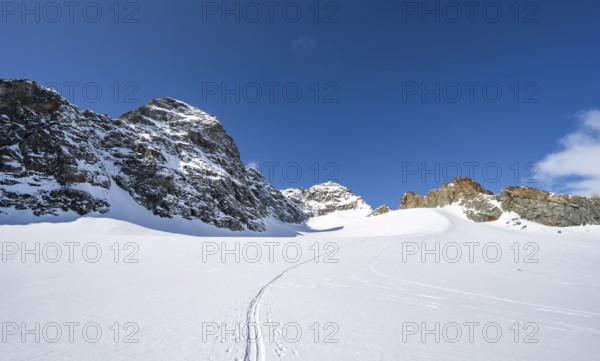 Rocky mountain peak of Piz Kesch and glacier Vadret da Porchabella in winter, mountain landscape,