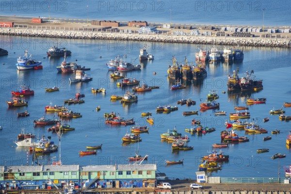 View from the Morro de Arica lookout mountain of the small colourful ships and boats in the fishing