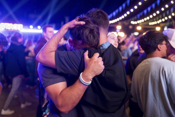 A fan of the England team is comforted at the Adidas fan zone at the Bundestag after the final