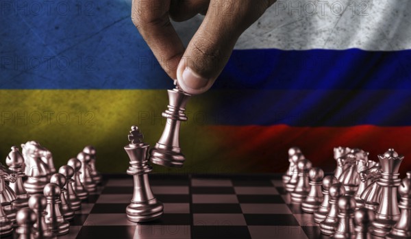 Russia vs Ukraine flag concept on chessboard. Political tension between Russia and Ukraine.