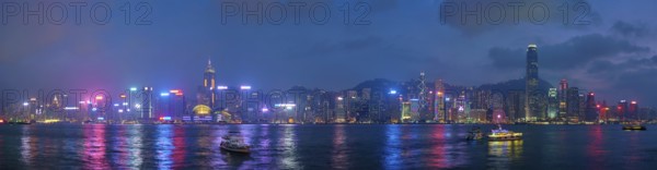 Panorama of Hong Kong skyline cityscape downtown skyscrapers over Victoria Harbour in the evening