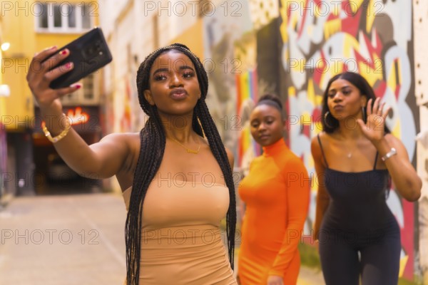 San Sebastián, Gipuzkoa Spain, February 2021: Three girls taking a selfie. Fashionable urban style
