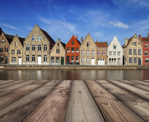 Wooden planks table with typical European Europe cityscape view, canal and medieval houses in