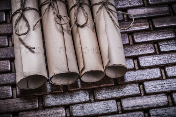 Pile of aged paper rolls on rowing wooden mat