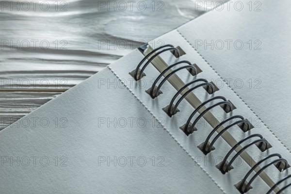Spiral notebook on white wooden board
