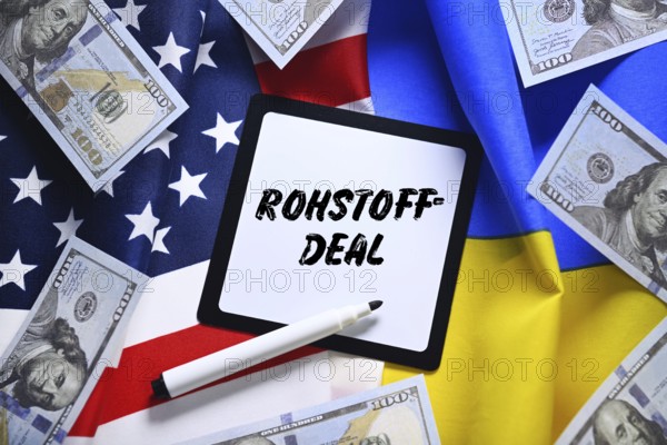 The flags of Ukraine and USA with dollar notes and plaque with the inscription raw materials deal,