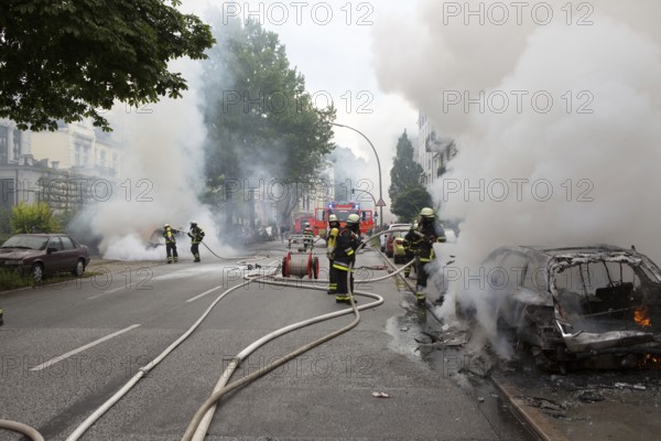 Fire brigade extinguishes burning cars on the Elbchaussee in Hamburg after the riots at the G20