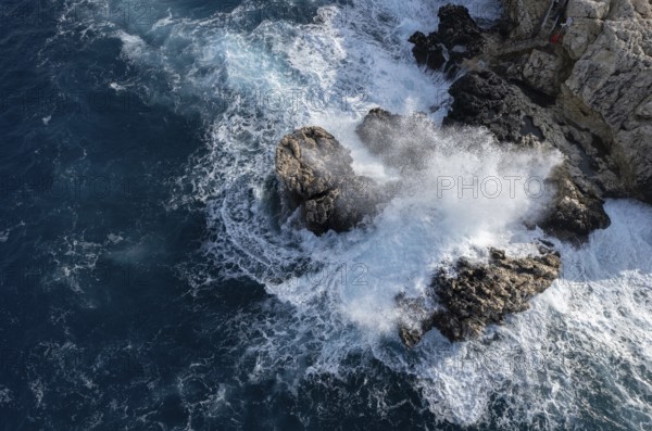 Drone aerial of rocky coast and stormy waves. Seascape windy waves. Stormy sea. Nature background.
