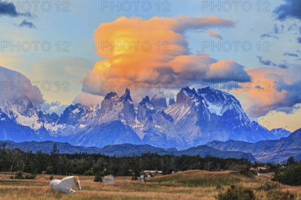 Incredible clouds illuminated by the sunset. The granite towers of Cuernos del Paine. White
