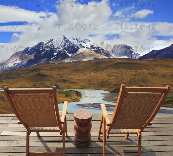 Pleasant holiday. Wooden chairs in the park Torres del Paine. Chile. On the horizon is visible