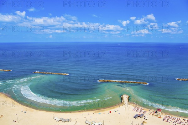 Magnificent sandy beach in Tel Aviv. Photo taken from the roof of a high-rise hotel. The blue