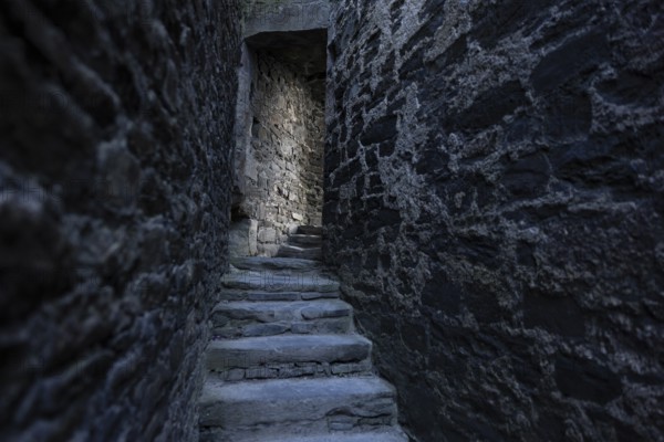 Conwy Castle, medieval stone staircase of the castle winds through narrow, dark and historic