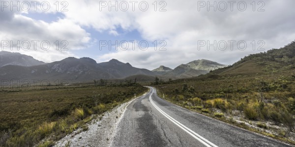 The picturesque Gordon River Rd at the Sentinel range of mountains near Bitumen Bones Sculpture on