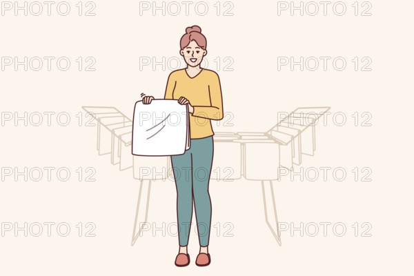Woman housewife stands near dryer with clean towels doing household chores to create comfort in