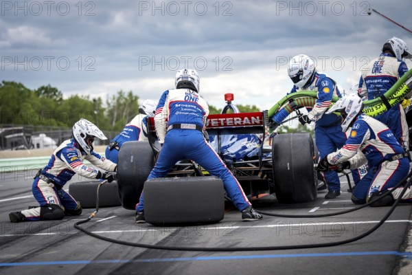 LINUS LUNDQVIST (R) (8) of Stockholm, Sweden comes down pit road for service during the XPEL Grand