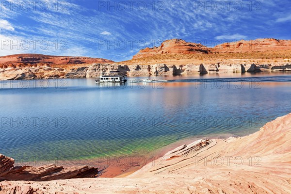 Lake Powell. The coast is cut by narrow canyons. USA. The smooth emerald water of the lake