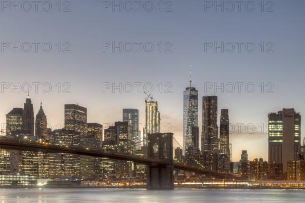 Skyline of Lower Manhattan and Brooklyn Bridge during sunset time