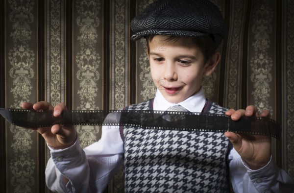 Child considered analog photographic film. Vintage clothes and background