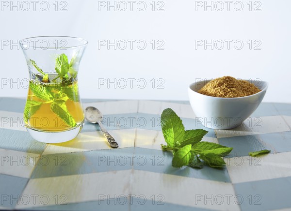 Green tea with mint Moroccan style on wood blue white table