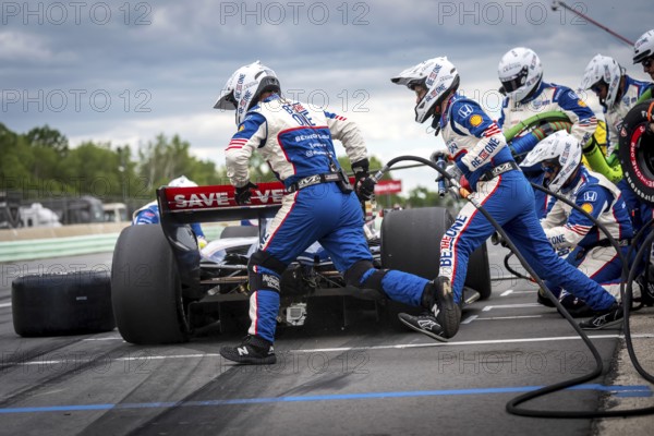 LINUS LUNDQVIST (R) (8) of Stockholm, Sweden comes down pit road for service during the XPEL Grand