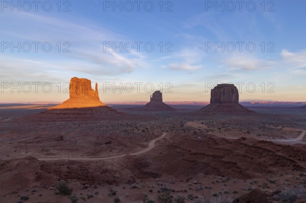 A picture of the Monument Valley landscape at sunset, with the West Mitten Butte, East Mitten Butte