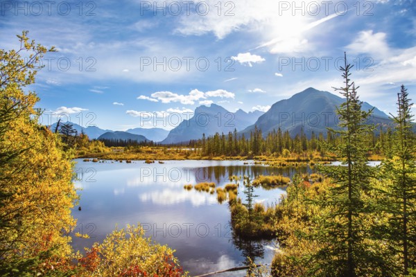 Grandiose landscape in the Rocky Mountains of Canada. Lake Vermillon among the yellow fall foliage
