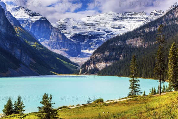 Travel to the Rocky Mountains of Canada. The lake with azure water is surrounded by mountains and