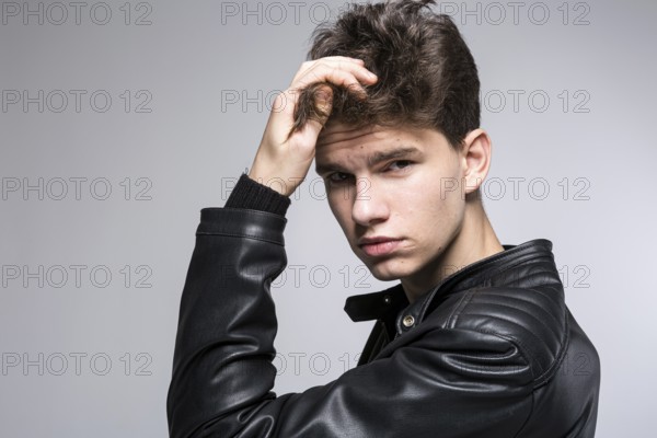 Hair care, health and wellness concept. portrait Of Confident, Charismatic man Touches With Hand,