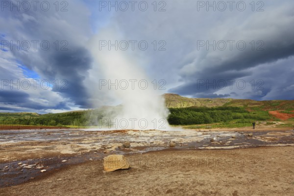 Iceland in the summer. Gushing geyser Strokkur. High column of hot water and steam from the crater