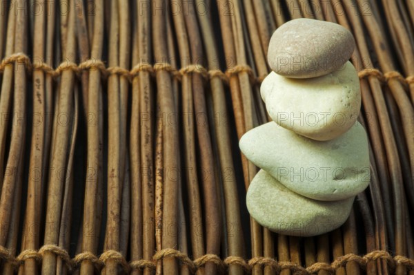Stacked stones on wooden base. Studio shot