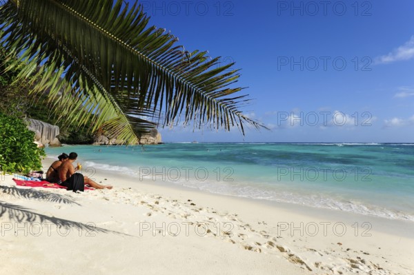 Couple on the beach Anse Source a Jean, Union Estate National Park, La Digue Island, the