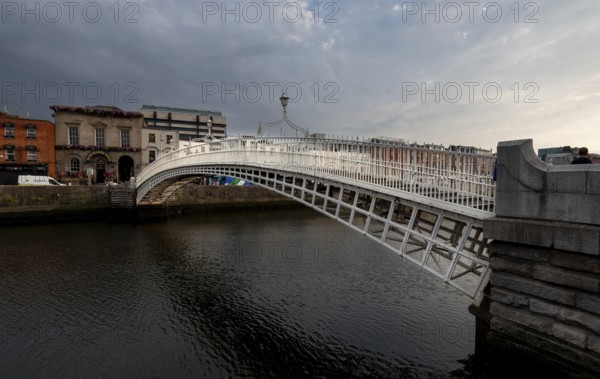 Dublin, Ireland, UK, June 19, 2022: Famous landmark of Ha' penny bridge over the river liffey