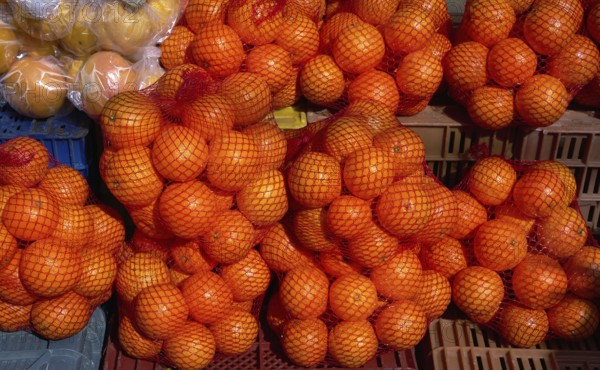 Oranges from Mediterranean in net bags at the outdoor market