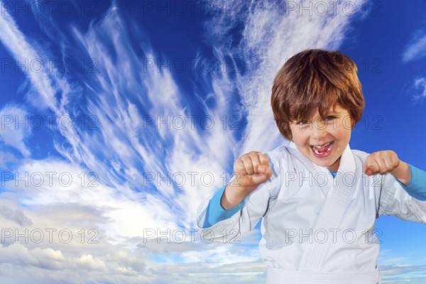 Concept - photo advertising, children, sports. Boy in a white kimono practices judo. Background -