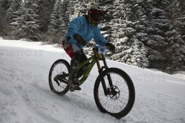 Sofia, Bulgaria - 22 January, 2022: Cyclist rides a bike downhill during an extreme snow riding
