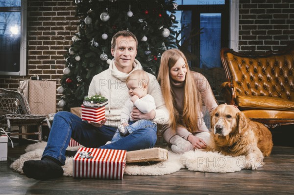 Theme Christmas and New Year family circle and domestic pet. Mom dad and child 1 year old Caucasian
