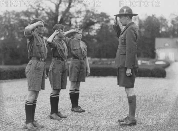 Folke Bernadotte, 1895-1948, leader of the swedish scouts movement saluting three boy scouts in the