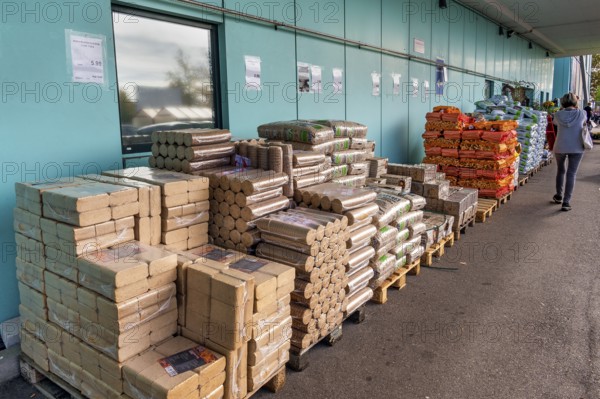Plastic bags with wood pellets, wood briquettes and firewood at a wholesale market, Allgäu,