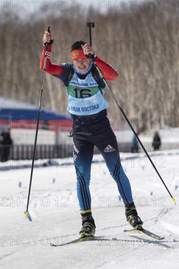 Sportsman biathlete Kapustin Aleksandr skiing on ski track distance biathlon stadium during Junior