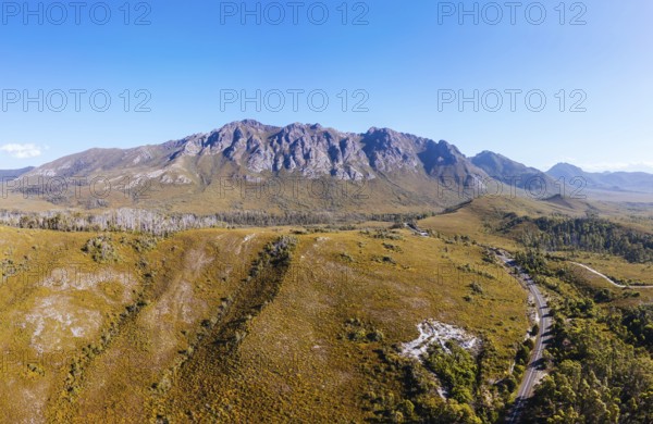 An aerial view of Gordon River Rd at the Sentinel range of mountains near Bitumen Bones Sculpture