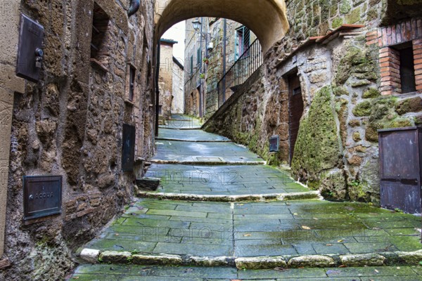 The tuff city of Sorano. Narrow street and covered bridge. Etruscan towns of Tuscany. Towns that