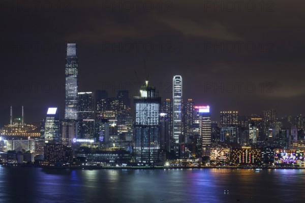 Symphony of Lights in night Hong Kong. Illuminated skyscrapers and colorful reflection in water