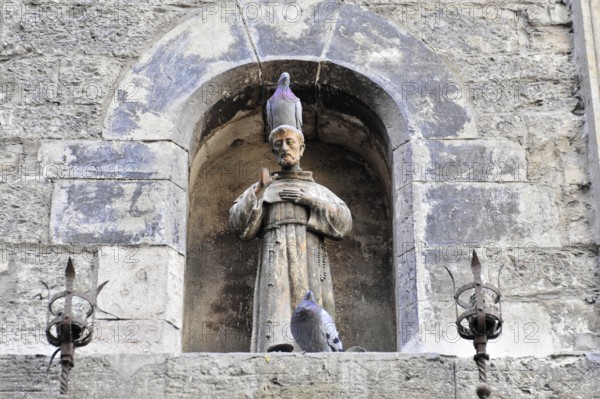 Assisi, Umbria, Italy, Europe, stone altar with a statue of a saint in the niche, decorated with
