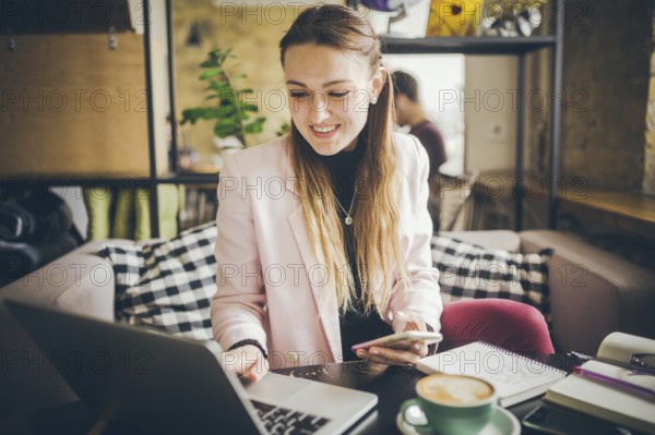 Beautiful Young Freelancer Woman Using Laptop Computer Sitting At Cafe Table. Businesswoman hand