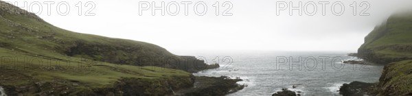 Typical landscape on the Faroe Islands, with green grass and rocks on Suduroy, Suduroy, Faroe