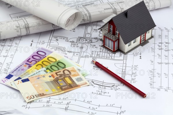An architect's construction plan with euro money. Symbolic photo for financing and planning a new